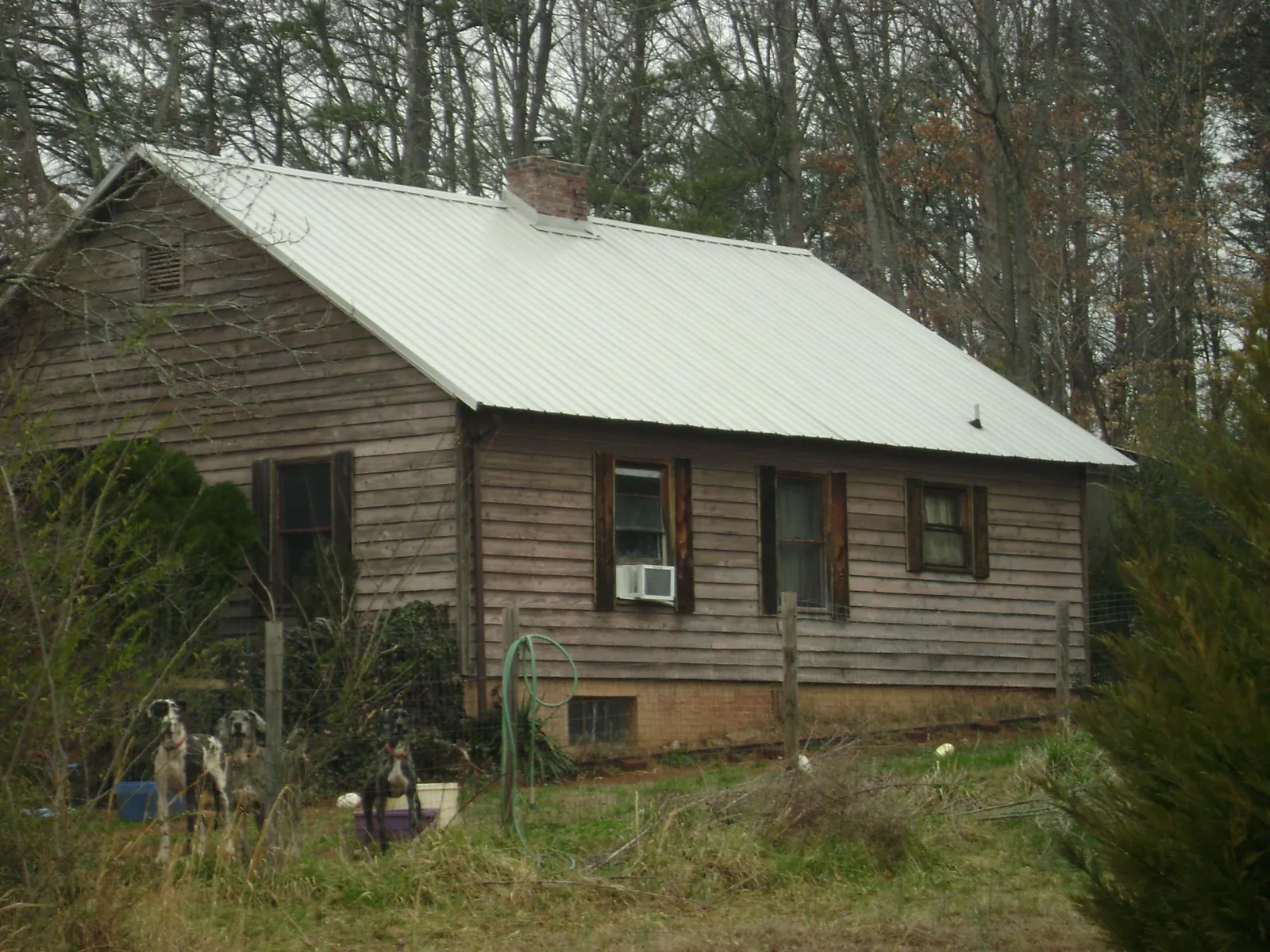 White metal roof on an old wood sided farmhouse, from a Metal Roof Installation job in Lexington Park